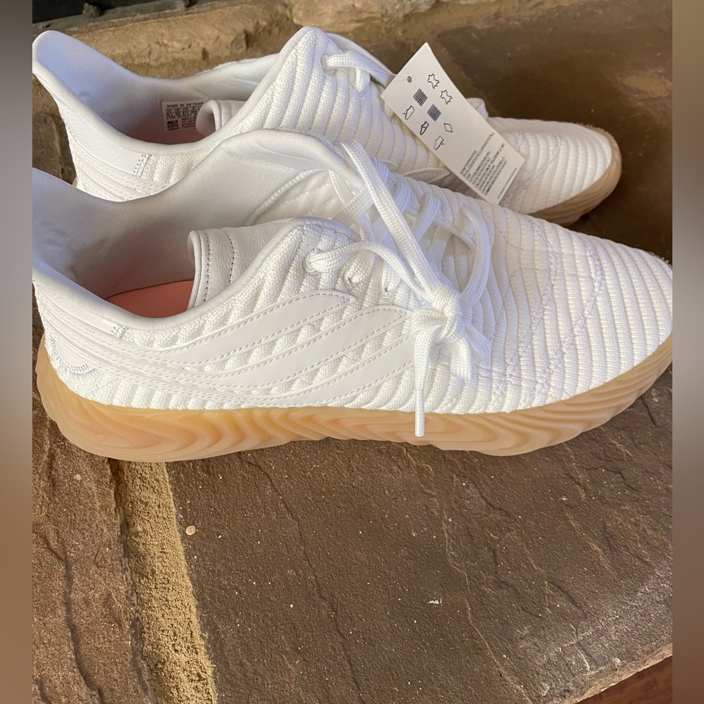 Brand New never worn white Adidas soccer shoes.